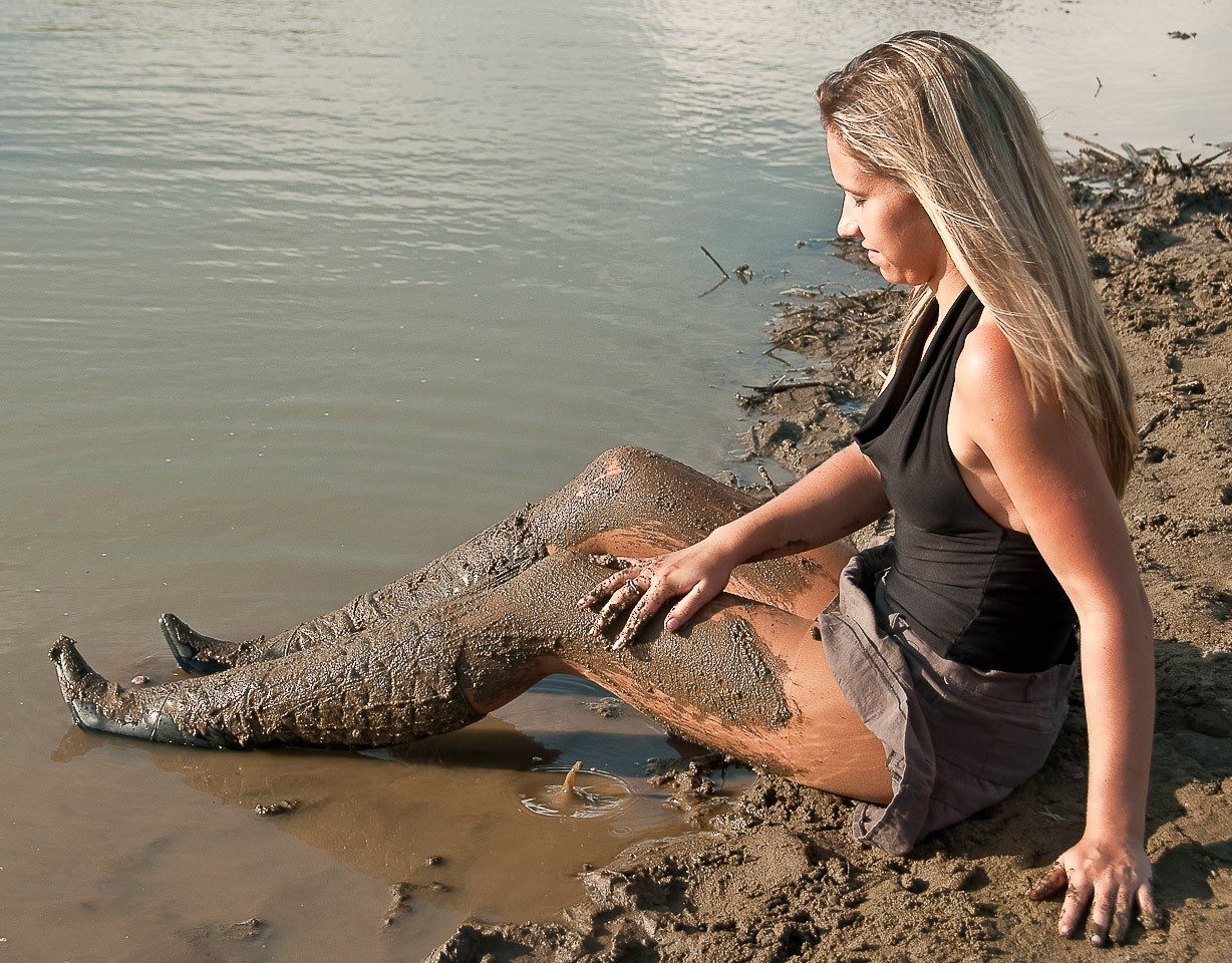 Blonde Messy Girl with Muddy Bare Legs and wearing Grey Miniskirt and Black Boots